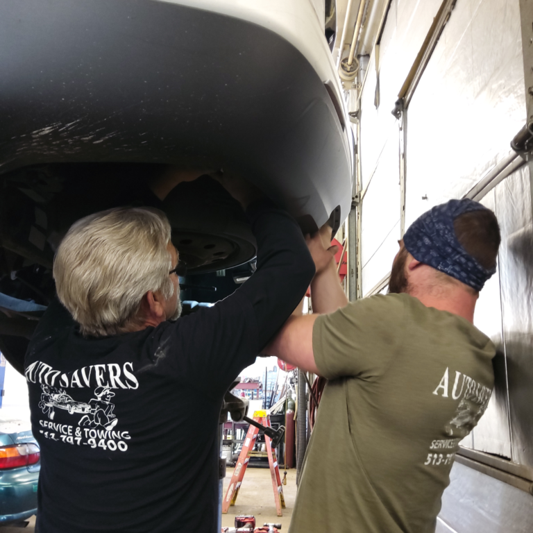 The Auto Savers team working on a vehicle on the shop lift